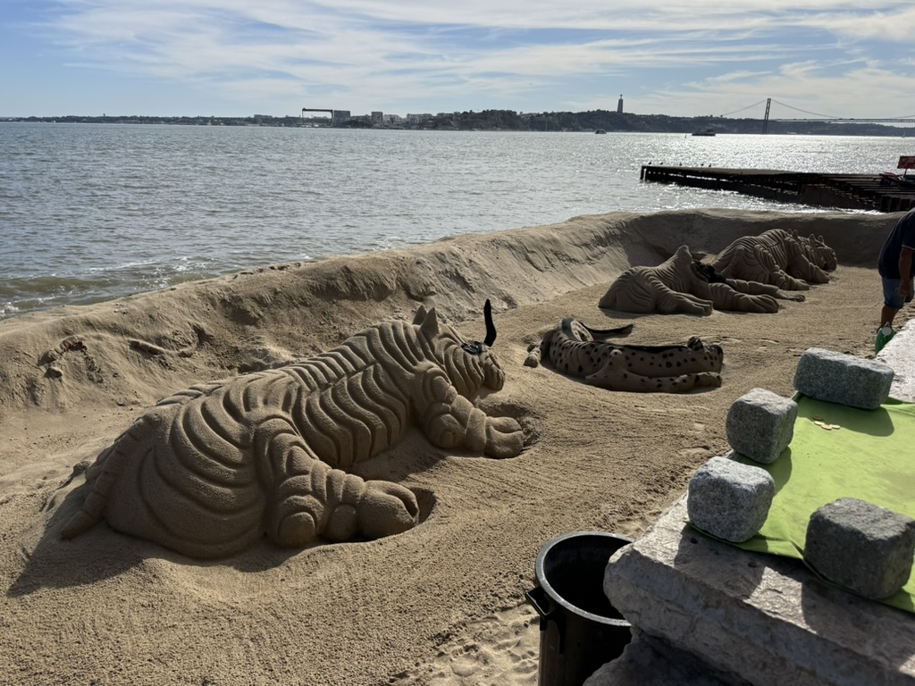 Sand art on the river in Lisbon